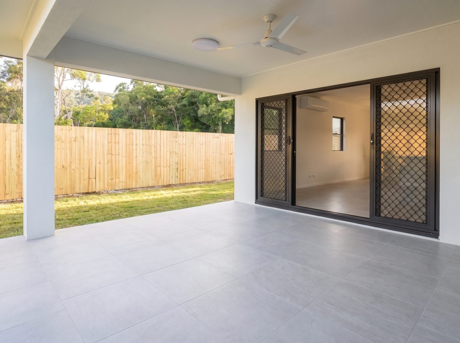 Patio before styling, plain with unlit interior lounge visible